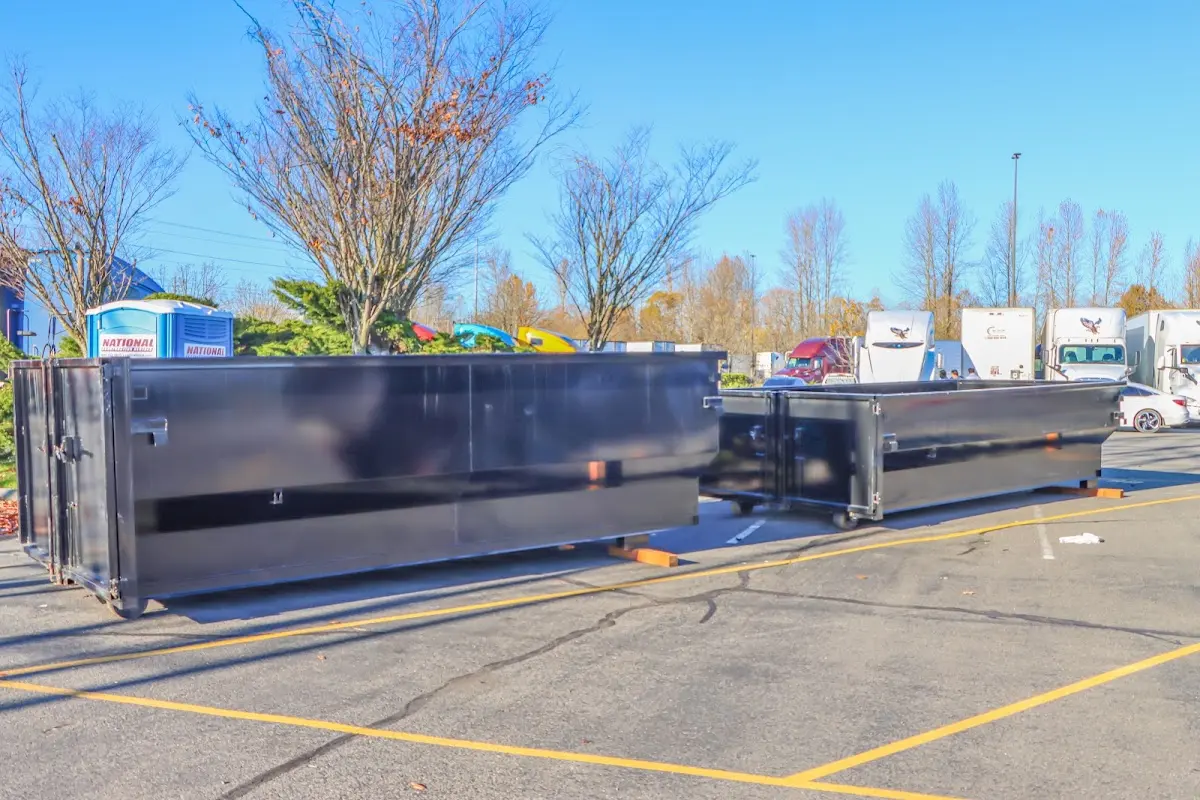 Professional dumpster rental service with roll-off container on residential driveway in Rochelle Park